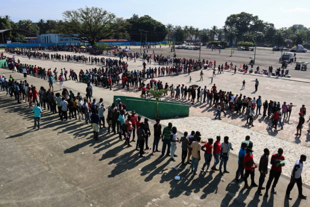 Migrants, mostly Haitians, wait for asylum processing by Mexico's Commission for Refugee Assistance (COMAR) outside a soccer stadium, in Tapachula, Mexico October 12, 2021. REUTERS/Jose Torres