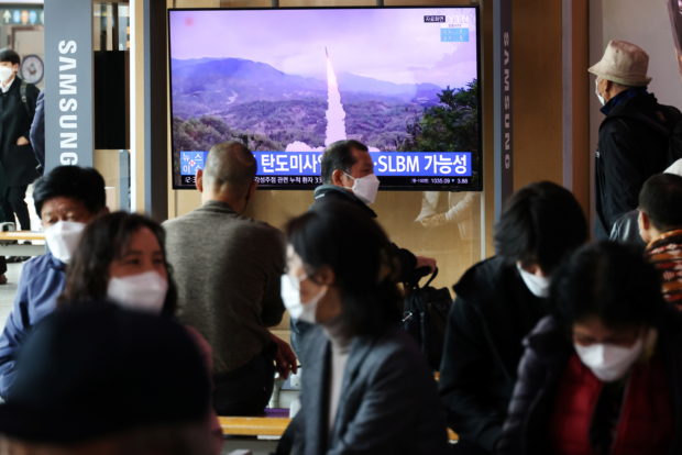 People watch a TV broadcasting file footage of a news report on North Korea firing a ballistic missile off its east coast, in Seoul, South Korea, October 19, 2021. REUTERS/Kim Hong-Ji