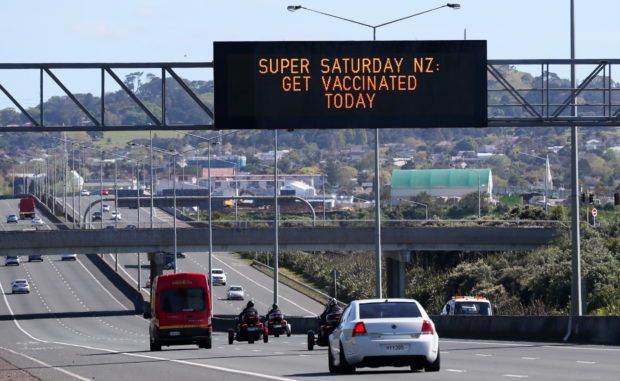 A sign on an Auckland motorway urges people to get vaccinated at a coronavirus disease (COVID-19) vaccination clinic during a single-day vaccination drive, aimed at significantly increasing the percentage of vaccinated people in the country, in Auckland, New Zealand, October 16, 2021.  REUTERS/Simon Watts