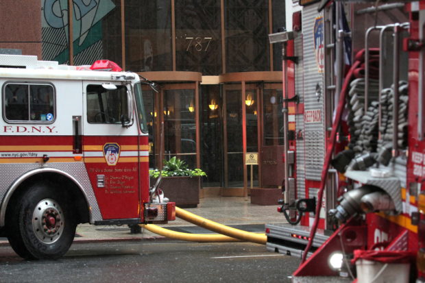FILE PHOTO: New York City Fire Department trucks are seen outside 787 7th Avenue in midtown Manhattan in New York City, New York, U.S., June 10, 2019. REUTERS/Brendan McDermid/File Photo