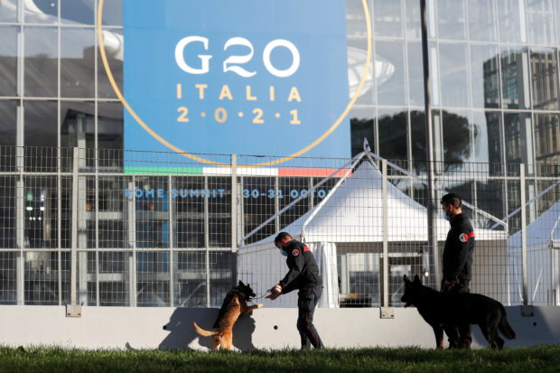 Carabinieri police officers inspect the area with explosive detection dogs outside the convention centre "La Nuvola" (the cloud) ahead of the G20 summit in Rome, Italy, October 27, 2021. REUTERS/Yara Nardi