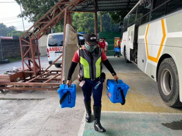 An employee of the Angeles City government carries the COVID-19 vaccine doses that were administered during a recent “Ronda Bakuna” program
