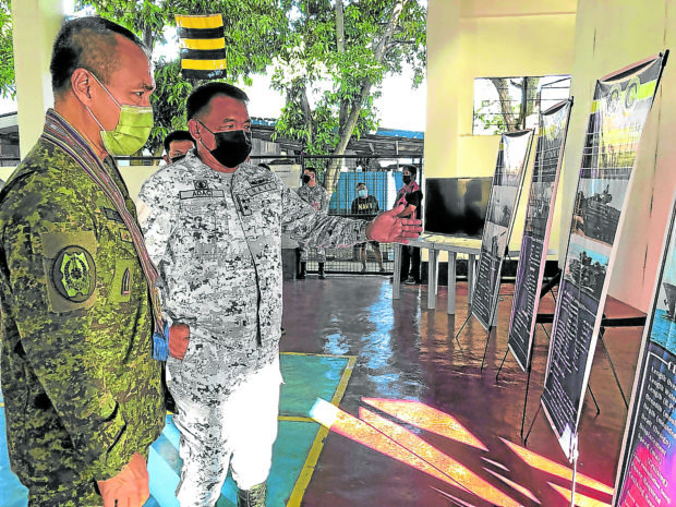 FILE PHOTO: Rear Admiral Toribio Adaci Jr., commander of the Naval Forces Western Mindanao, shows Maj. Gen. Alfredo Rosario Jr., chief of the Western Mindanao Command, photos of the armaments to be used in the Pagsisikap Exercise 2021. —JULIE S. ALIPALA