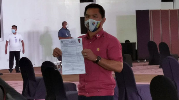 Senator Manny Pacquiao shows to the media his certificate of candidacy or COC form at the Harbor Garden Tent of Sofitel hotel in Pasay City on Friday, October 1, 2021. Pacquiao makes his bid for president in the 2022 elections official with the filing of his COC. INQUIRER.net/John Eric Mendoza