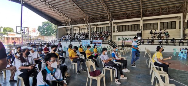 College students in La Union province wait for their turn to receive jabs against COVID-19. (Photo courtesy of Commission on Higher Education-Ilocos region