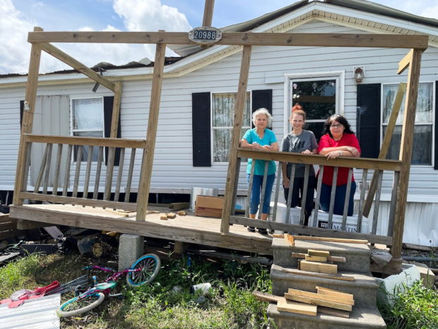 Rosie Verdin, along with her daughters Gabrielle Rosenberger (middle) and Nathanie Verdin, pose for a photo on the porch of Rosie’s mobile home in Golden Meadow