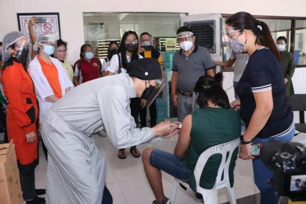 A minor gets vaccinated in Caloocan City on Oct. 22, 2022, the first day of the second phase of vaccination of children with comorbidities.