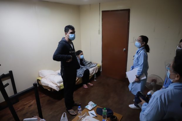 Officers of the Senate Medical and Dental Bureau (MDB) conduct a medical check-up on arrested Pharmally executives Mohit and Twinkle Dargani following their arrival at the Senate Sunday evening, November 14, 2021