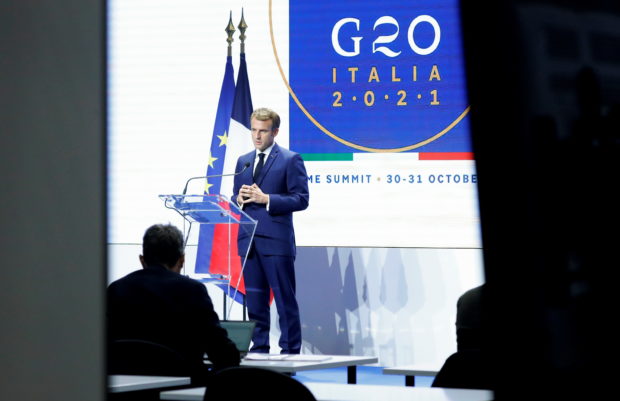 French President Emmanuel Macron speaks during the G20 summit in Rome, Italy, October 31, 2021. Picture taken through glass. REUTERS/Remo Casilli