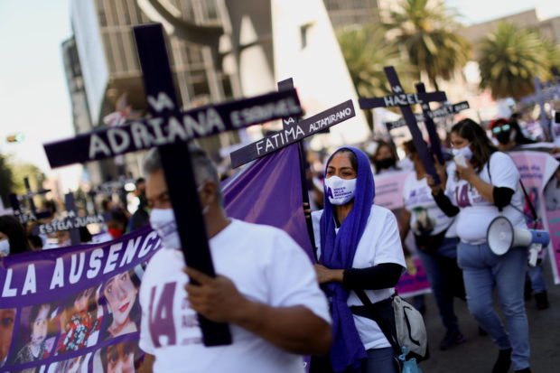 Clutching graveyard crosses, hundreds protest violence vs women in Mexico