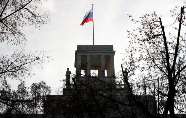 FILE PHOTO: The national flag flutters on top of the Russian embassy after Germany expelled two Russian diplomats in Berlin, Germany, December 4, 2019.    REUTERS/Fabrizio Bensch