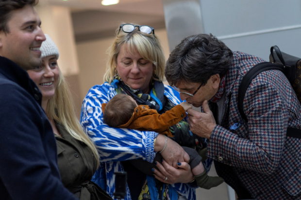 Jill and Stephen Brownbill react as they meet their newly borne grandson Rocco while arriving at John F. Kennedy International Airport as the U.S. reopens land borders to coronavirus disease (COVID-19) vaccinated travellers for the first time since the COVID-19 restrictions were imposed, in New York, U.S., November 8, 2021. REUTERS/Carlos Barria