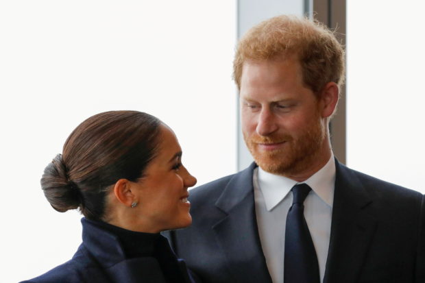 FILE PHOTO: Britain's Prince Harry and Meghan, Duke and Duchess of Sussex, look at each other during a visit to One World Trade Center in Manhattan, New York City, U.S., September 23, 2021. REUTERS/Andrew Kelly