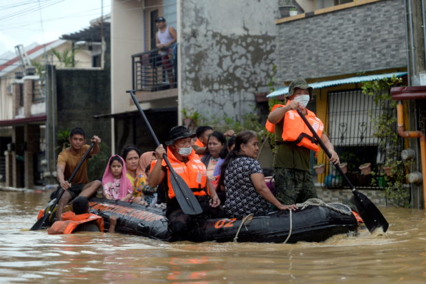 Residents on a rescue boat are evacuated from their flooded houses following Typhoon Vamco, in Rizal Province, Philippines, November 12, 2020. REUTERS/Lisa Marie David/File Photo