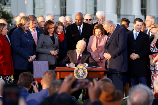 U.S. President Joe Biden signs the "Infrastructure Investment and Jobs Act", on the South Lawn at the White House in Washington, U.S., November 15, 2021. REUTERS/Jonathan Ernst
