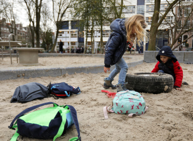 FILE PHOTO: Children are seen leaving school on a Friday after a nation-wide ban on large public gatherings to avoid coronavirus spreading in Amsterdam, Netherlands March 13, 2020. REUTERS/Eva Plevier