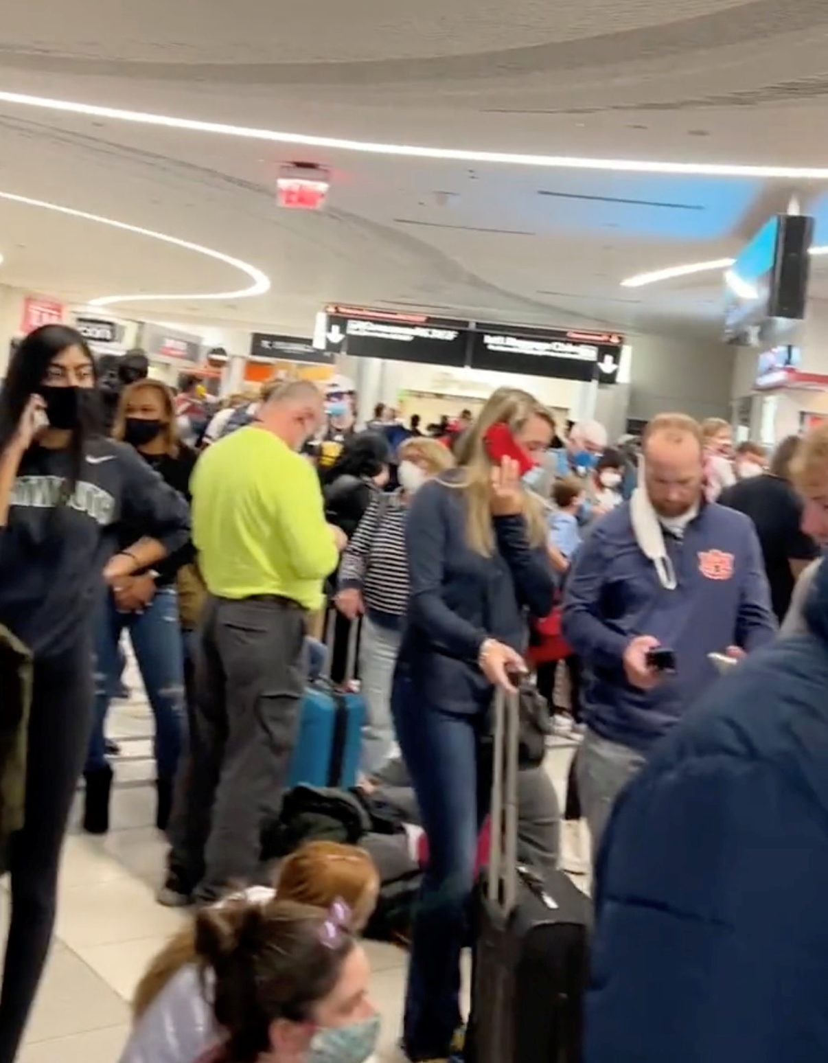 People gather to leave Hartsfield-Jackson Atlanta International Airport after reported shooting, in Atlanta, Georgia, U.S., November 20, 2021, in this still image obtained from a social media video. Twitter/mohiterajas/via REUTERS