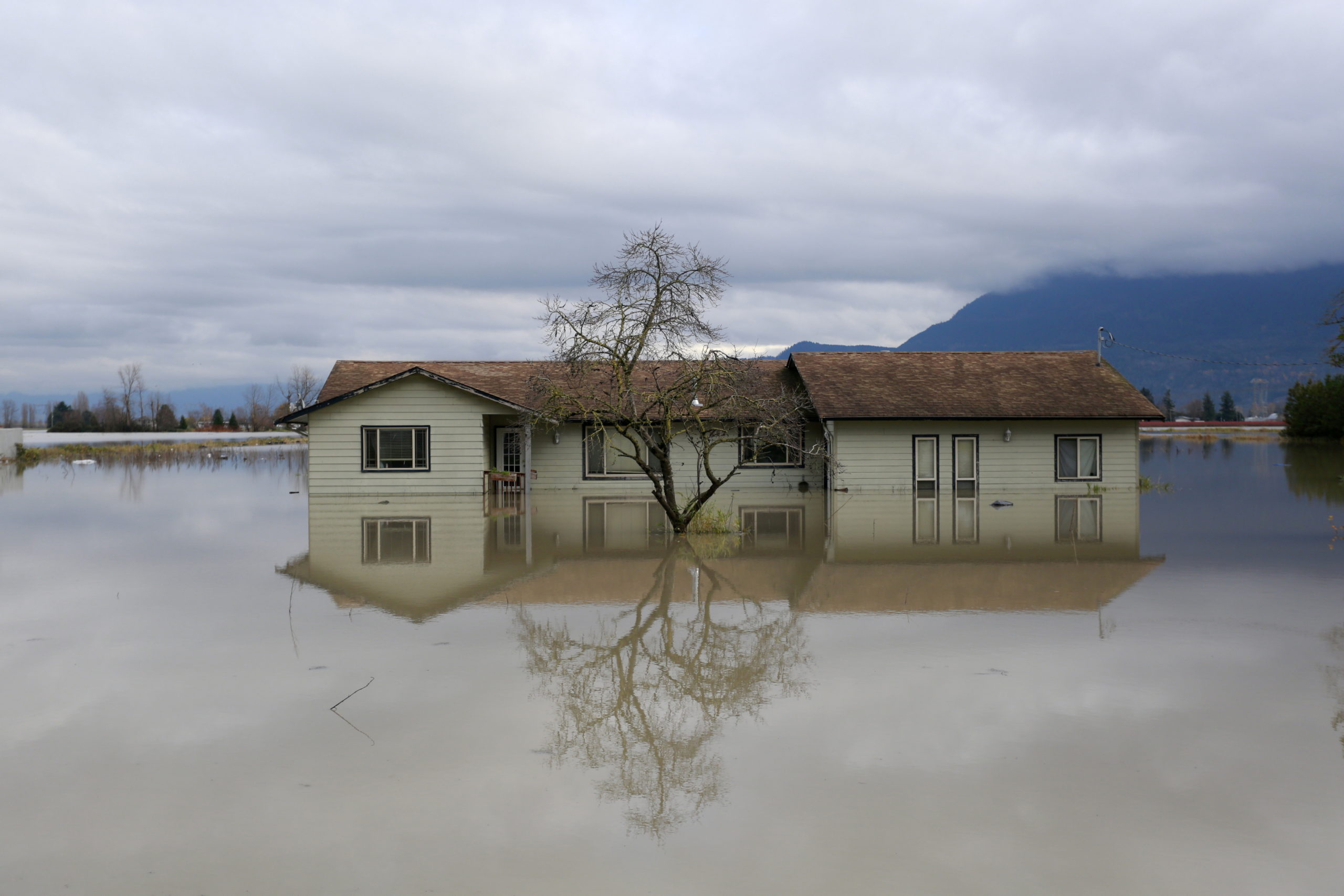 A home surrounded by floodwaters in the Yarrow neighbourhood after rainstorms caused flooding and landslides in Chilliwack, British Columbia, Canada November 20, 2021. REUTERS/Jesse Winter