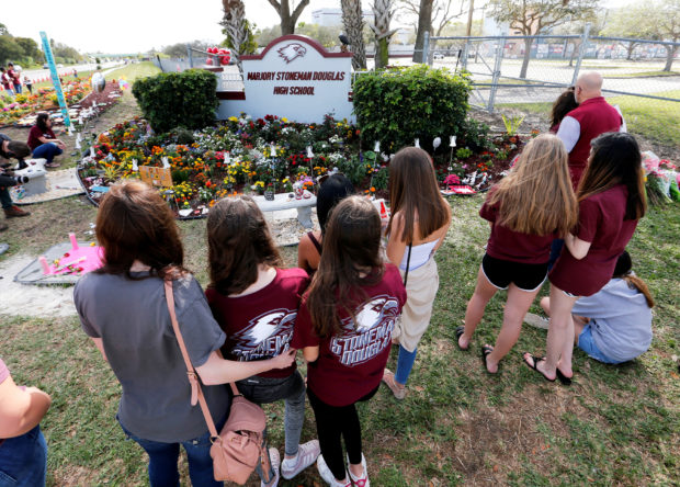 FILE PHOTO: A memorial is viewed by parents and students on campus at a memorial on the one year anniversary of the shooting which claimed 17 lives at Marjory Stoneman Douglas High School in Parkland, Florida, U.S., February 14, 2019.   REUTERS/Joe Skipper