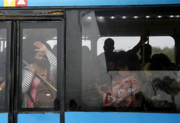 People travel on a bus during the vaccination campaign against the coronavirus disease (COVID-19) inside a Bus Rapid Transit (BRT) station in Rio de Janeiro, Brazil October 27, 2021. REUTERS/Pilar Olivares