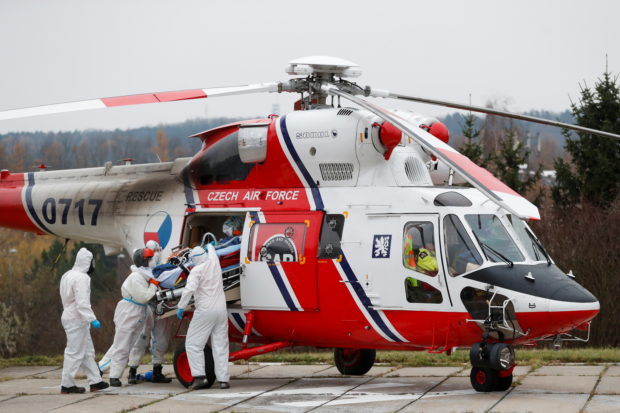 Medical workers transport a coronavirus disease (COVID-19) patient, who is being transferred from a Brno hospital by a Czech Air Force helicopter, in Prague, Czech Republic, November 25, 2021. REUTERS/David W Cerny