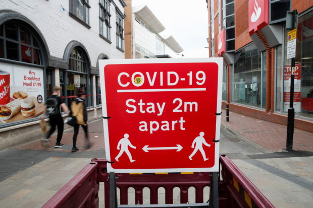 FILE PHOTO: A social distancing sign is seen amid the spread of the coronavirus disease (COVID-19), in Leicester, Britain, May 27, 2021. REUTERS/Andrew Boyers