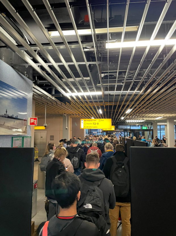Passengers travelling from South Africa queue to be coronavirus disease (COVID-19) tested  after being held on the tarmac at Schiphol Airport, Netherlands Novemver 25, 2021, in this picture obtained from social media and obtained by REUTERS