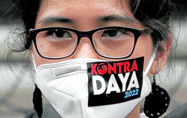 Woman wearing face mask with Kontra Daya sticker. STORY: Comelec pressed to act on OAV complaints