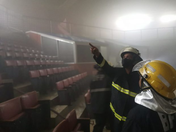 A fireman inspects the gallery of the Cuneta Astrodome where fire broke out. Image from BFP-NCR