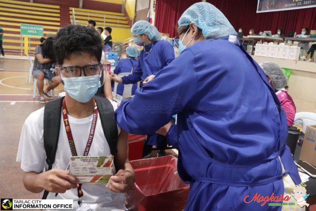 A college student gets vaccinated against COVID-19 at the Tarlac State University’s gymnasium. (Photo courtesy of the Tarlac City Information Office)