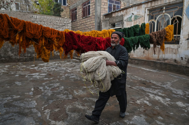 Afghan families go back to making carpets as economy unravels
