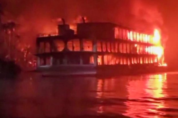 This frame grab from an AFPTV video shows a burning ferry after it caught on fire killing at least 37 people in Jhalkathi, 250 kilometers (160 miles) south of Dhaka, early on December 24, 2021. (Photo by AFPTV / AFP)