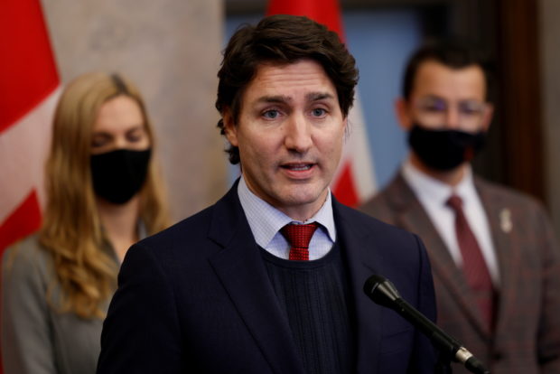 Canada's Prime Minister Justin Trudeau, with Minister of Sport Pascale St-Onge and Parliamentary Secretary to the Minister of Sport Adam van Koeverden, speaks during a press conference on Parliament Hill in Ottawa, Ontario, Canada, December 8, 2021. REUTERS/Blair Gable