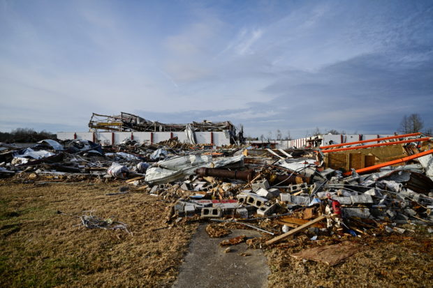 Debris from a destroyed factor is seen at sunset after tornadoes ripped through several U.S. states in downtown Dawson Springs, Kentucky, U.S., December 14, 2021. REUTERS/Jon Cherry