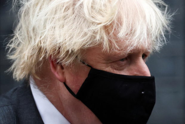 FILE PHOTO: British Prime Minister Boris Johnson walks outside Downing Street in London, Britain, December 15, 2021. REUTERS/Henry Nicholls