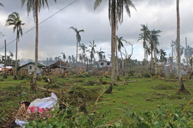 FILE PHOTO: Houses and trees damaged by typhoon Rai are seen, in Surigao del Norte province, Philippines, December 18, 2021. Picture taken December 18, 2021. Philippine Coast Guard/Handout via REUTERS