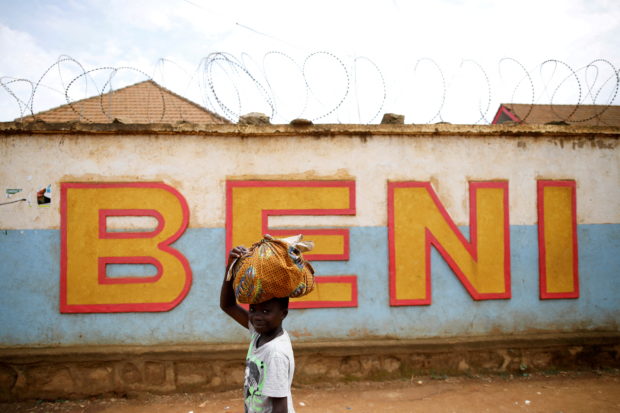 FILE PHOTO: A Congolese boy walks past a wall in Beni, in the Democratic Republic of Congo, April 1, 2019. Picture taken April 1, 2019.REUTERS/Baz Ratner/File Photo