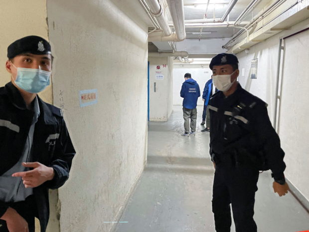 Police stand guard outside the Stand News office after six people were arrested "for conspiracy to publish seditious publication" according to Hong Kong's Police National Security Department, in Hong Kong, China, December 29, 2021. REUTERS/James Pomfert