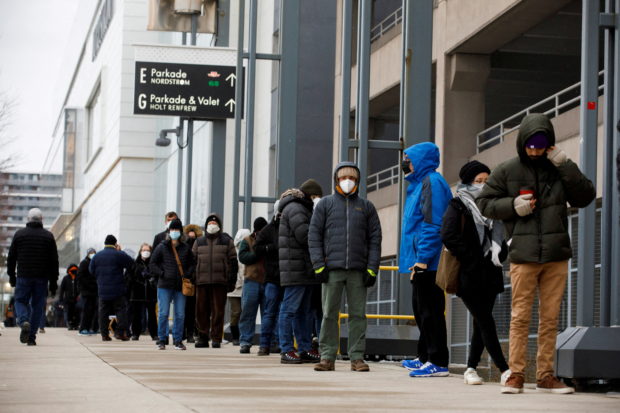People queue to pick up coronavirus disease (COVID-19) antigen test kits, as the latest Omicron variant emerges as a threat, at Yorkdale Mall in Toronto, Ontario, Canada December 22, 2021. REUTERS/Cole Burston
