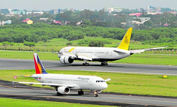 Royal Brunei Dreamliner and PAL planes on the runway. STORY: Summer passenger arrivals to hit up to 12,000 daily
