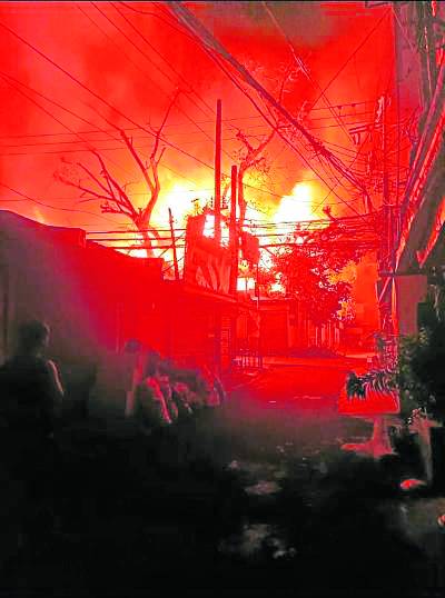 A fire breaks out in a residential area in Barangay Sambag 2, Cebu City, on Dec. 25, razing 13 houses and leaving about 100 people homeless.