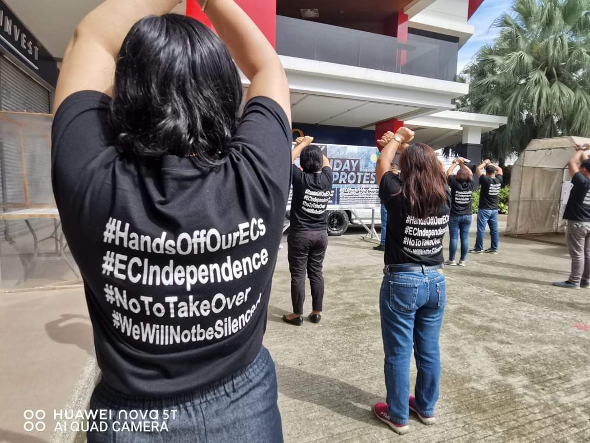 Wearing black shirts opposing what they called "franchise-grabbing" by the Davao Light and Power Company, workers of the Northern Davao Electric Cooperative, Inc. join the Black Friday protest outside their office building in Tagum City
