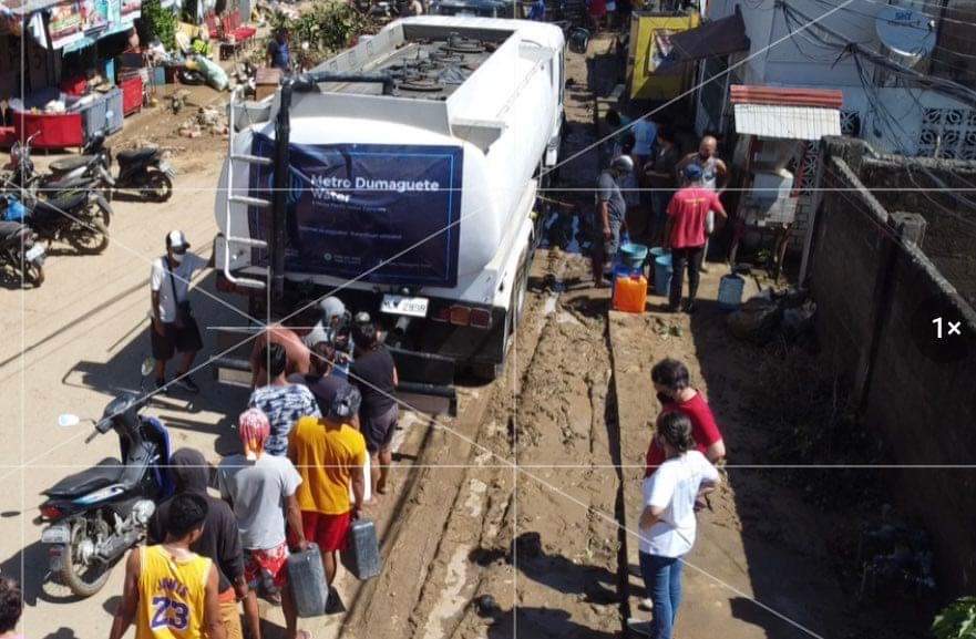 People line up for drinking water in Bais City, Negros Oriental