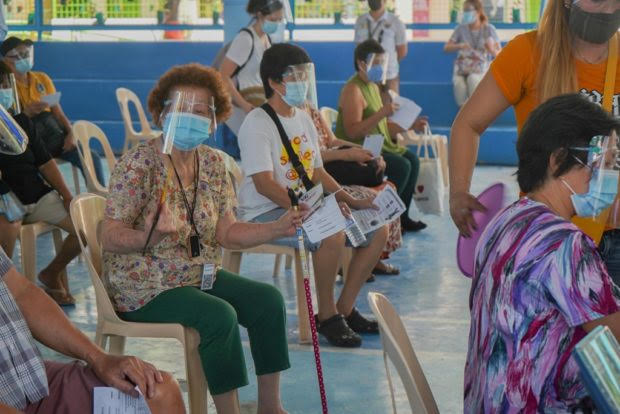 Seniors wait for turn to get vaccinated in Valenzuela, for story: LGUs must vaccinate 80% of seniors to be on Alert Level 1