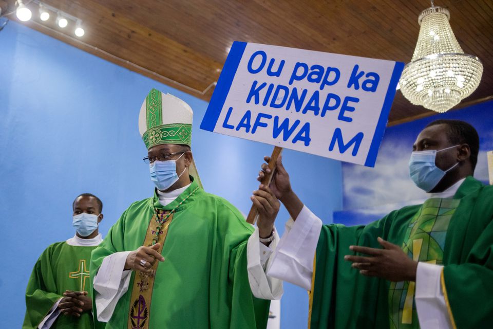 Metropolitan Archbishop of Port-au-Prince, Max Leroy Mesidor, carries card "You cannot kidnap my faith"