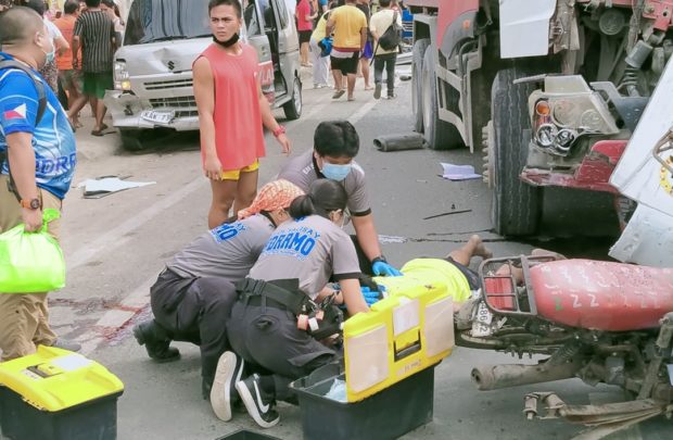 Rescuers attend to one of the victims of a road mishap on Dec. 3 in Talisay City, south Cebu. (Photo courtesy of Joy Tumulak)