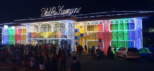Residents enjoy the spectacle of lights at the town hall and plaza of once war-torn Kauswagan, Lanao del Norte