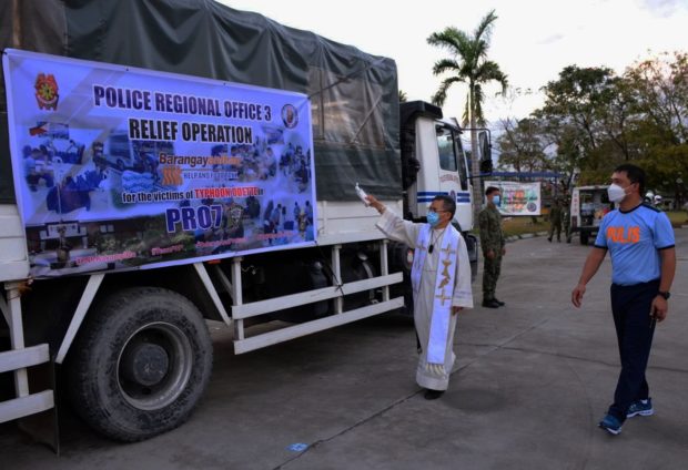The chaplain of Camp Julian Olivas blesses one of the trucks carrying relief packs for Cebu typhoon victims