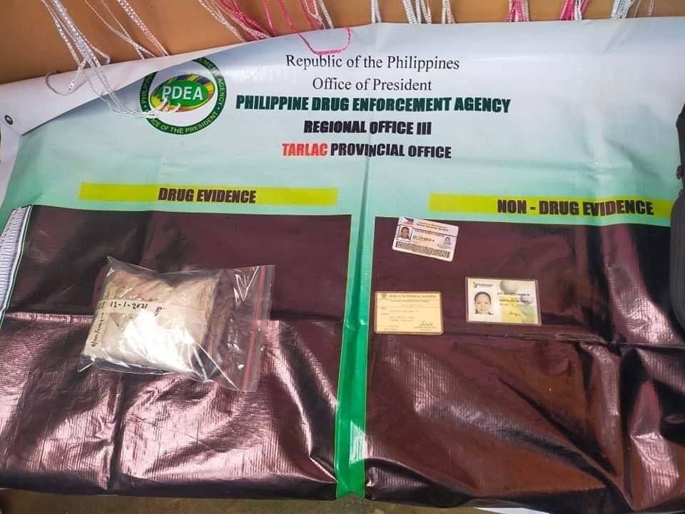 The alleged shabu inside a small zip-lock plastic bag seized by authorities and the identification cards of the suspect