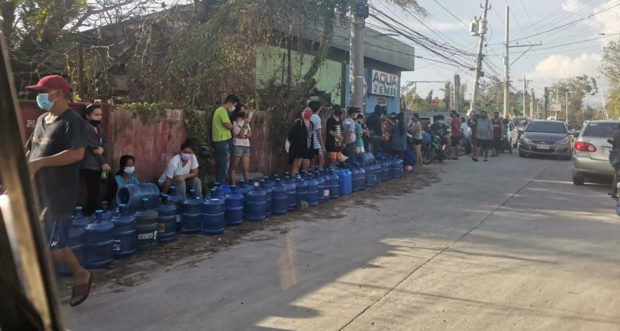 Residents in Tagbilaran City, Bohol, line up their containers at a water refilling station on Saturday, Dec. 18, 2021. Bohol has no power and water service after super typhoon Odette devastated Bohol province. Leo Udtohan/Inquirer Visayas
